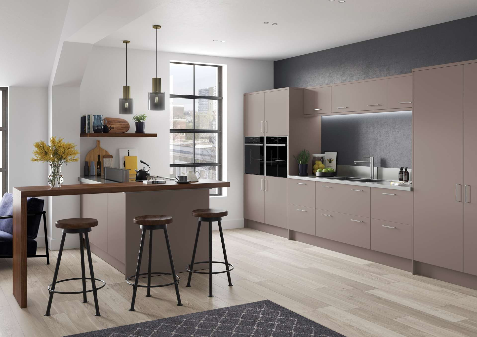 Modern kitchen featuring matte taupe cabinets, a wooden breakfast bar with three stools, and a dark accent wall.