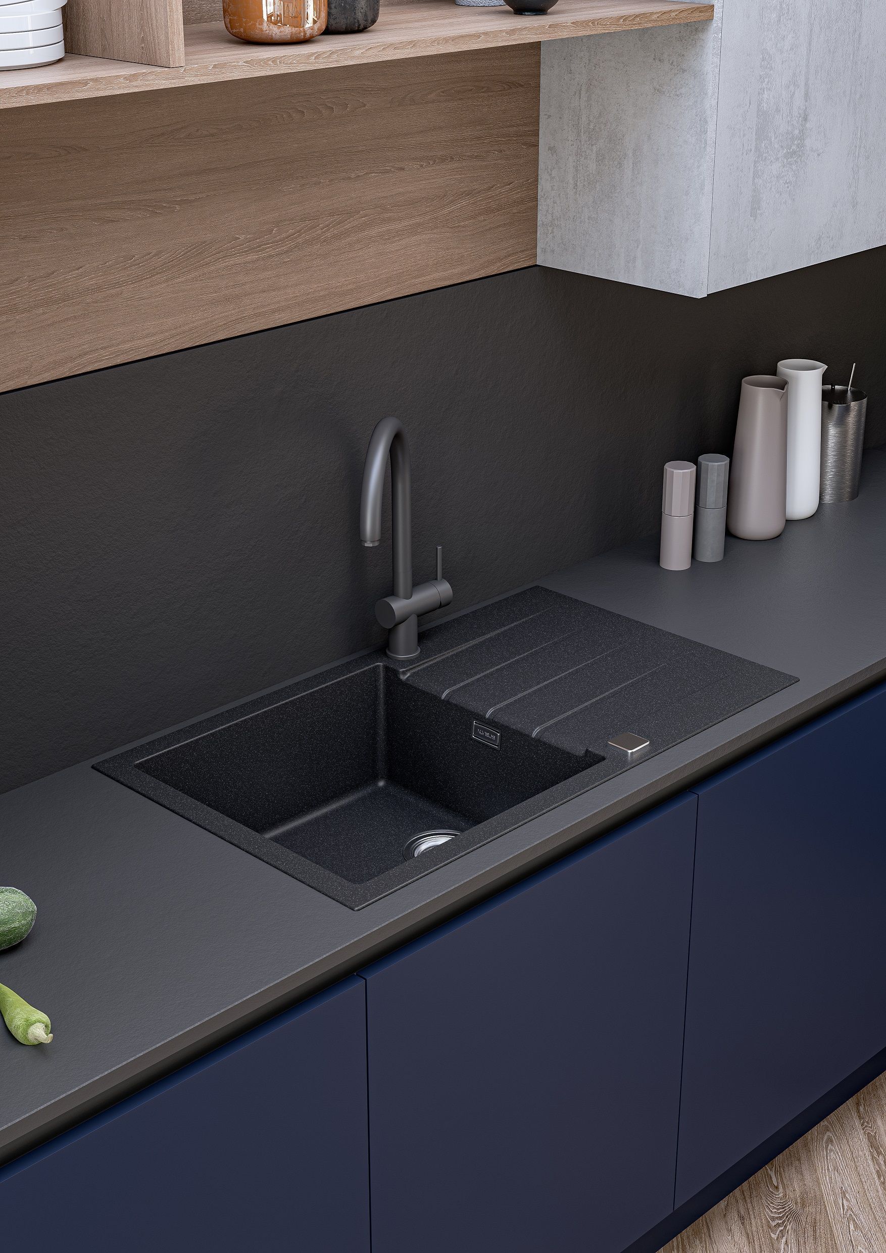 A black granite kitchen sink with a modern matte black faucet, set into a dark countertop above deep blue cabinets.