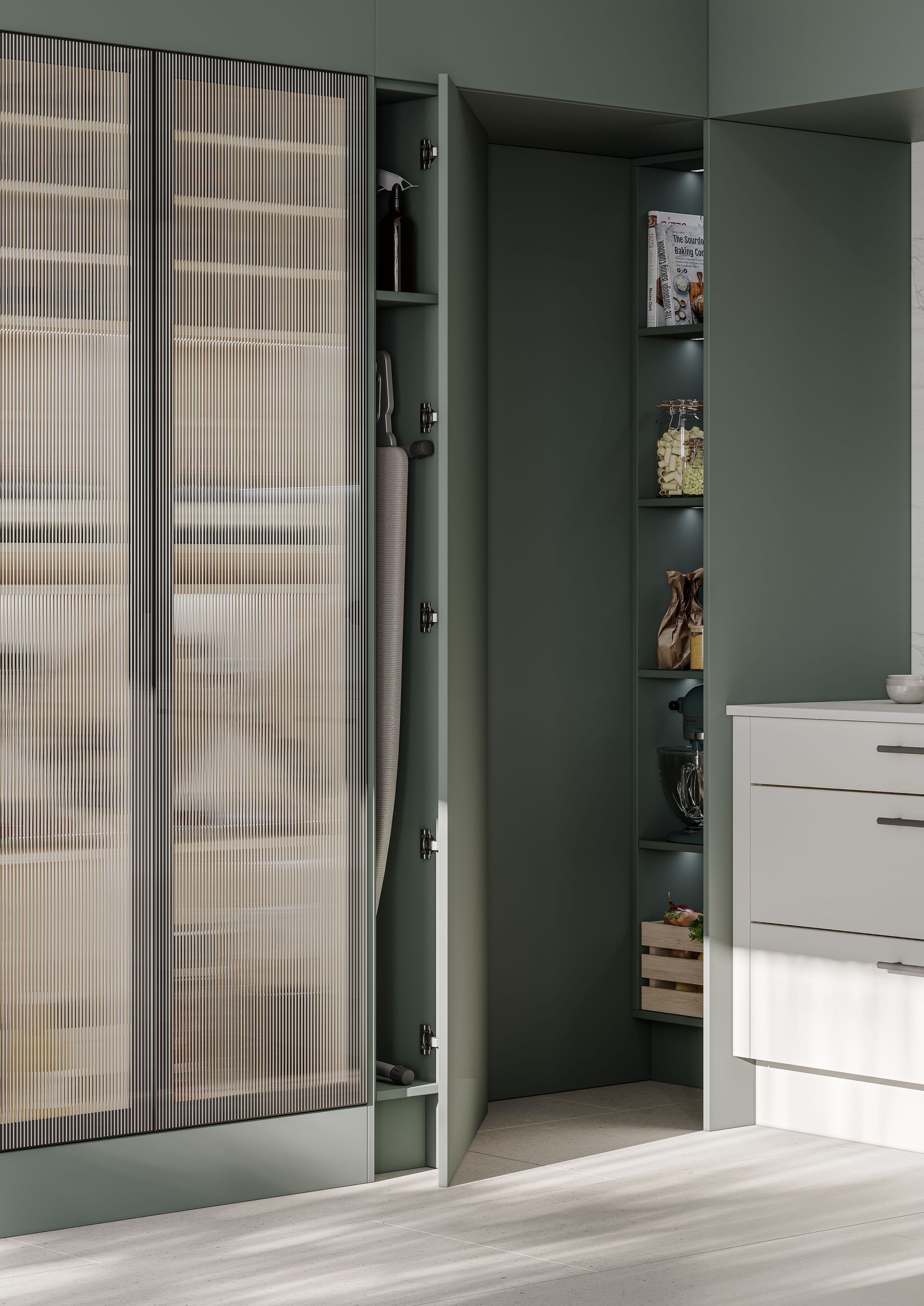 A sage green kitchen cabinet with slatted wooden doors, a narrow storage niche, and an open, illuminated pantry corner.