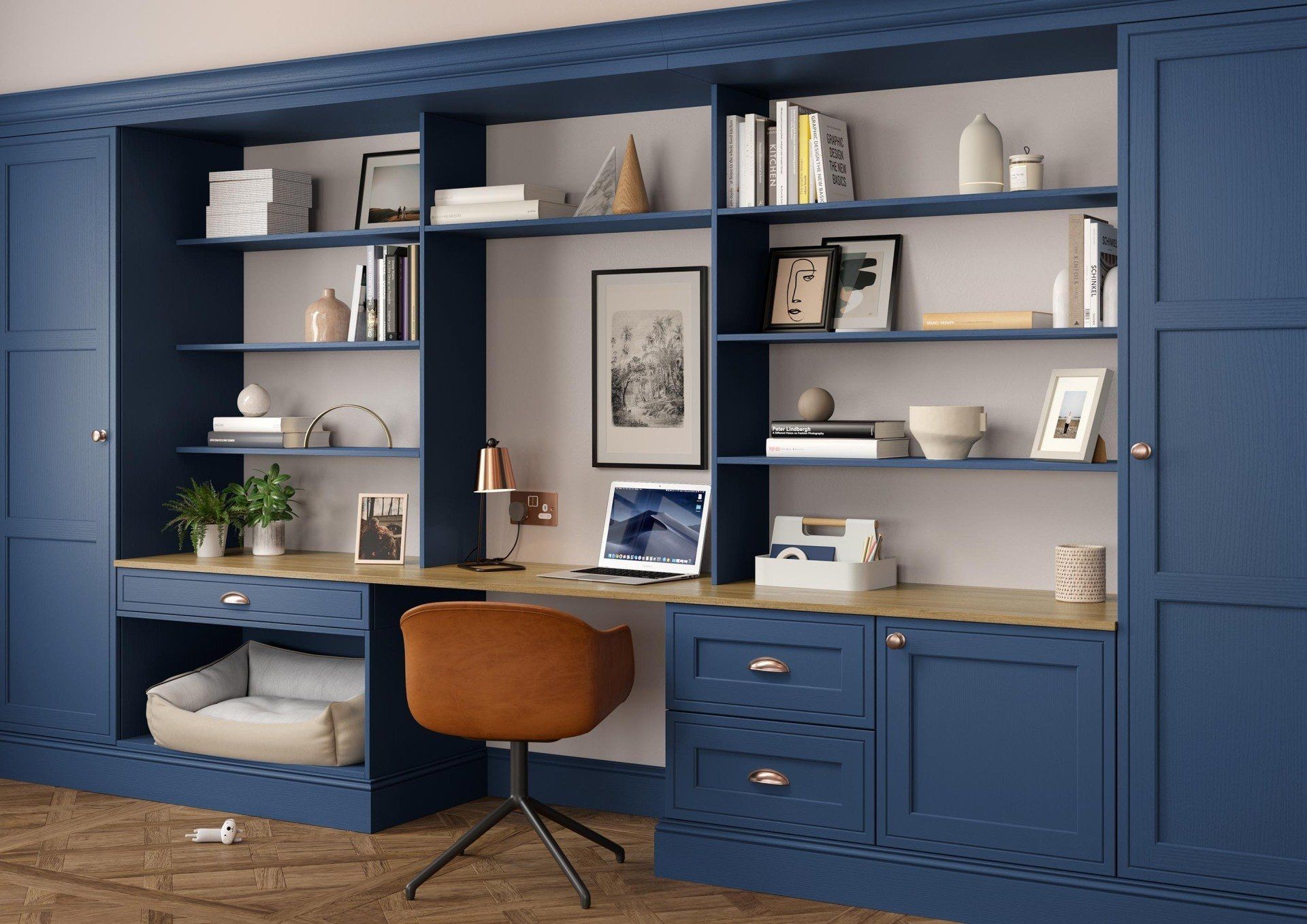 A home office setup featuring a desk and shelves in deep blue cabinetry, centered by a brown chair against a white wall.