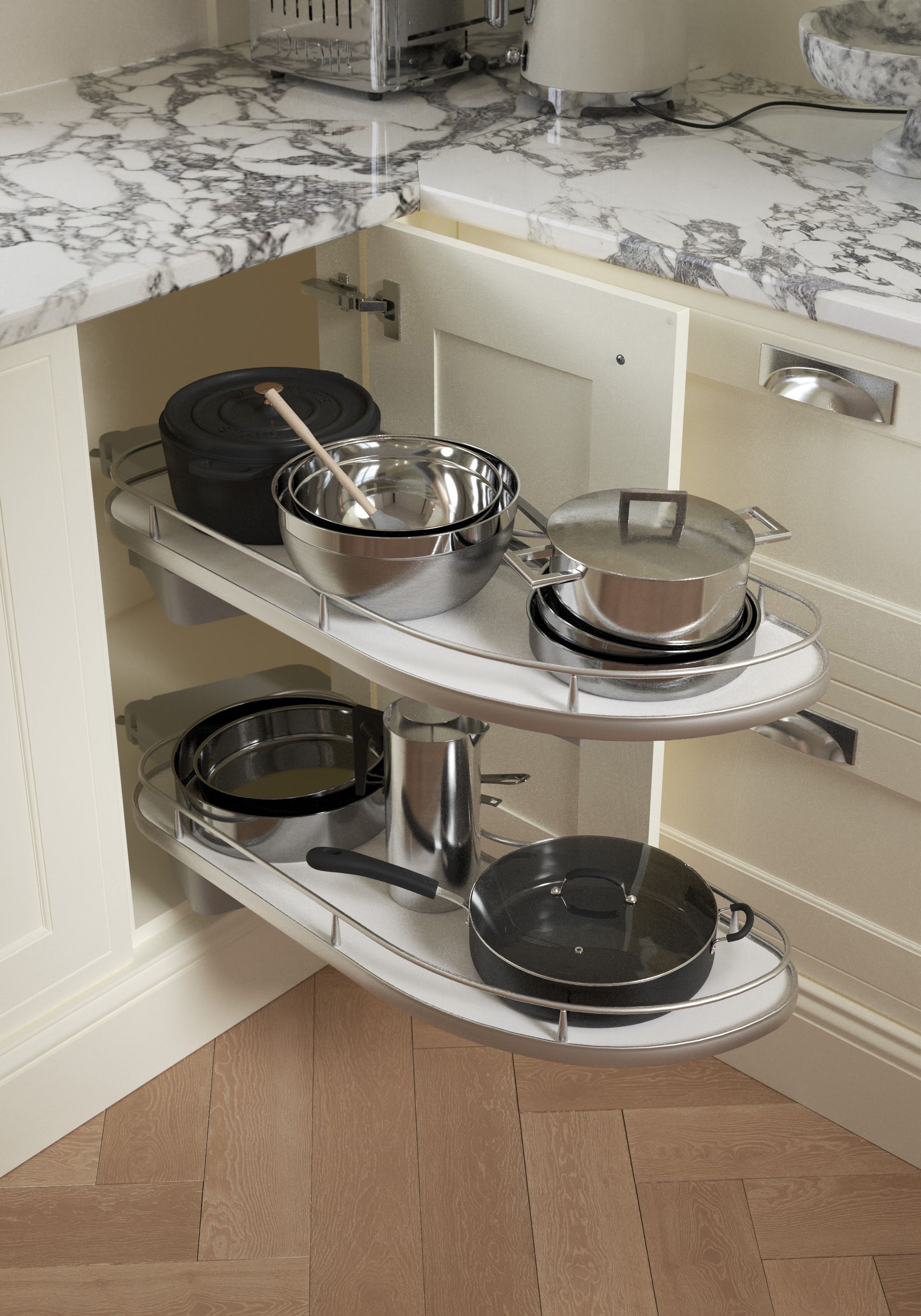 A corner kitchen cabinet with two semi-circular pull-out shelves holding various pots and pans.
