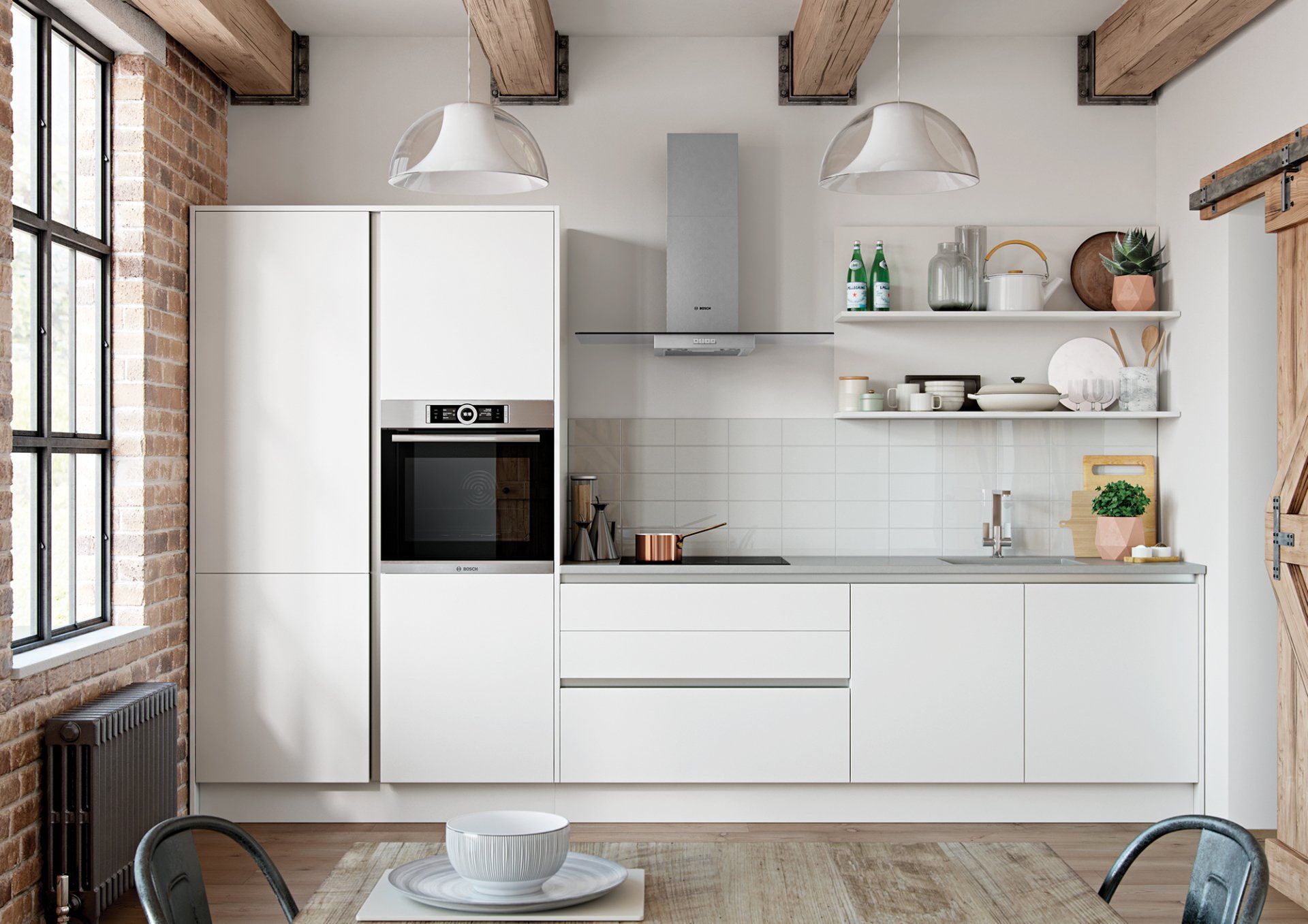 A modern, minimalist kitchen with white cabinets, a built-in oven, open shelves, and exposed brick walls.