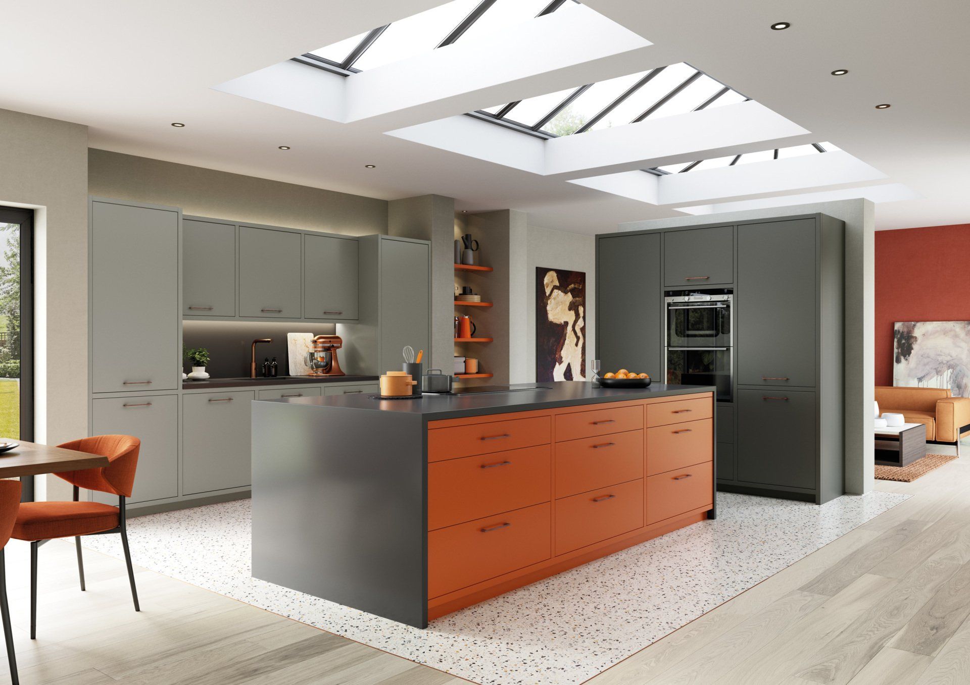 A modern kitchen featuring grey cabinets, a vibrant orange island, skylights, and a terrazzo-style floor.