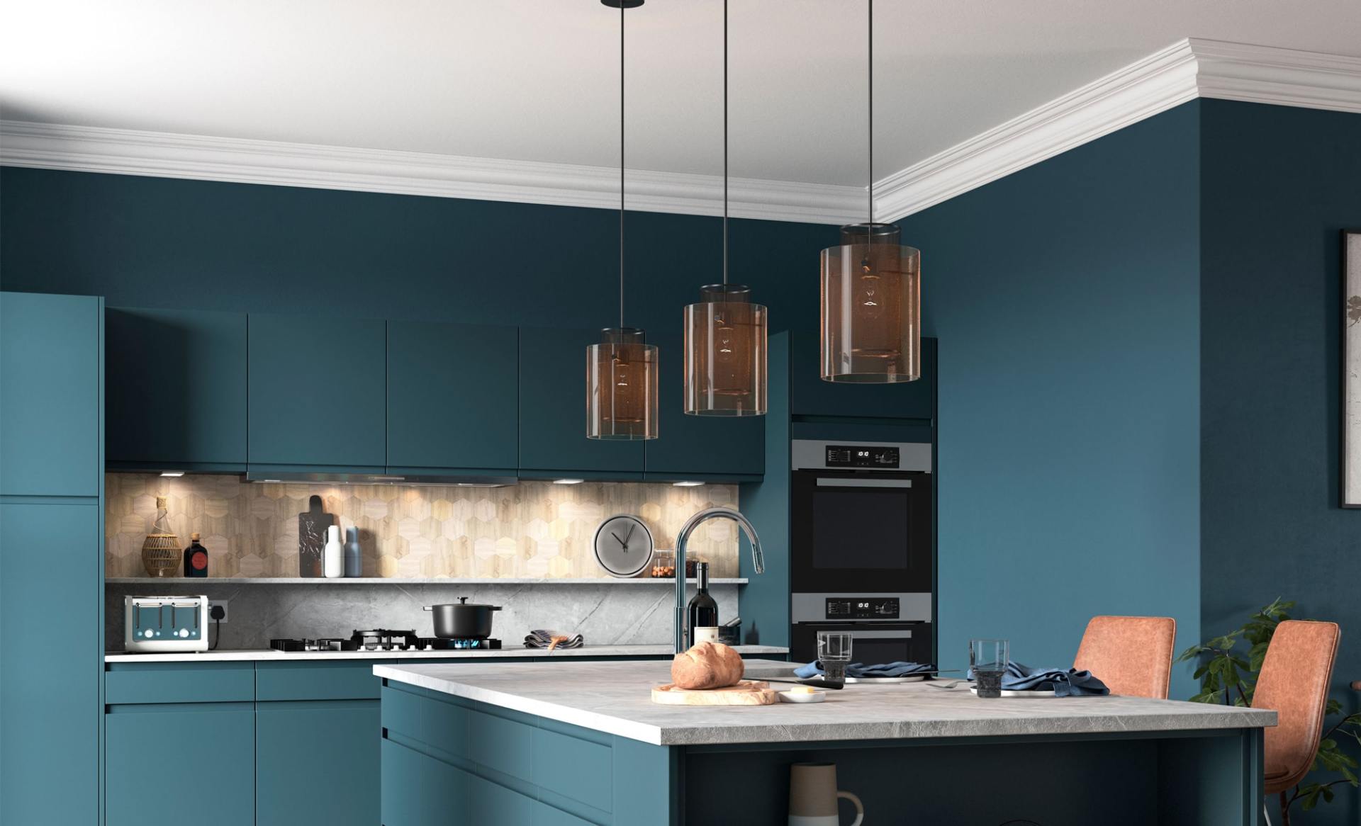 A modern kitchen featuring teal cabinets, a light marble-topped island, three glass pendant lights, and built-in appliances.
