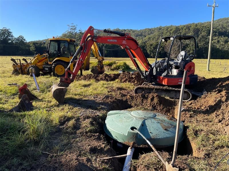 A Septic Tank Is Being Installed In A Hole In The Ground — Tim Larkin Plumbing and Excavations in Laurieton, NSW