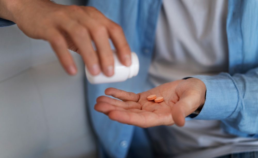 Man pouring some tablets on his hands