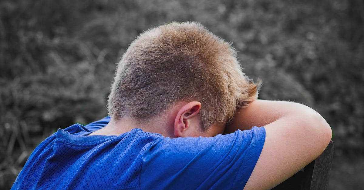 Upset child with his head in his arms