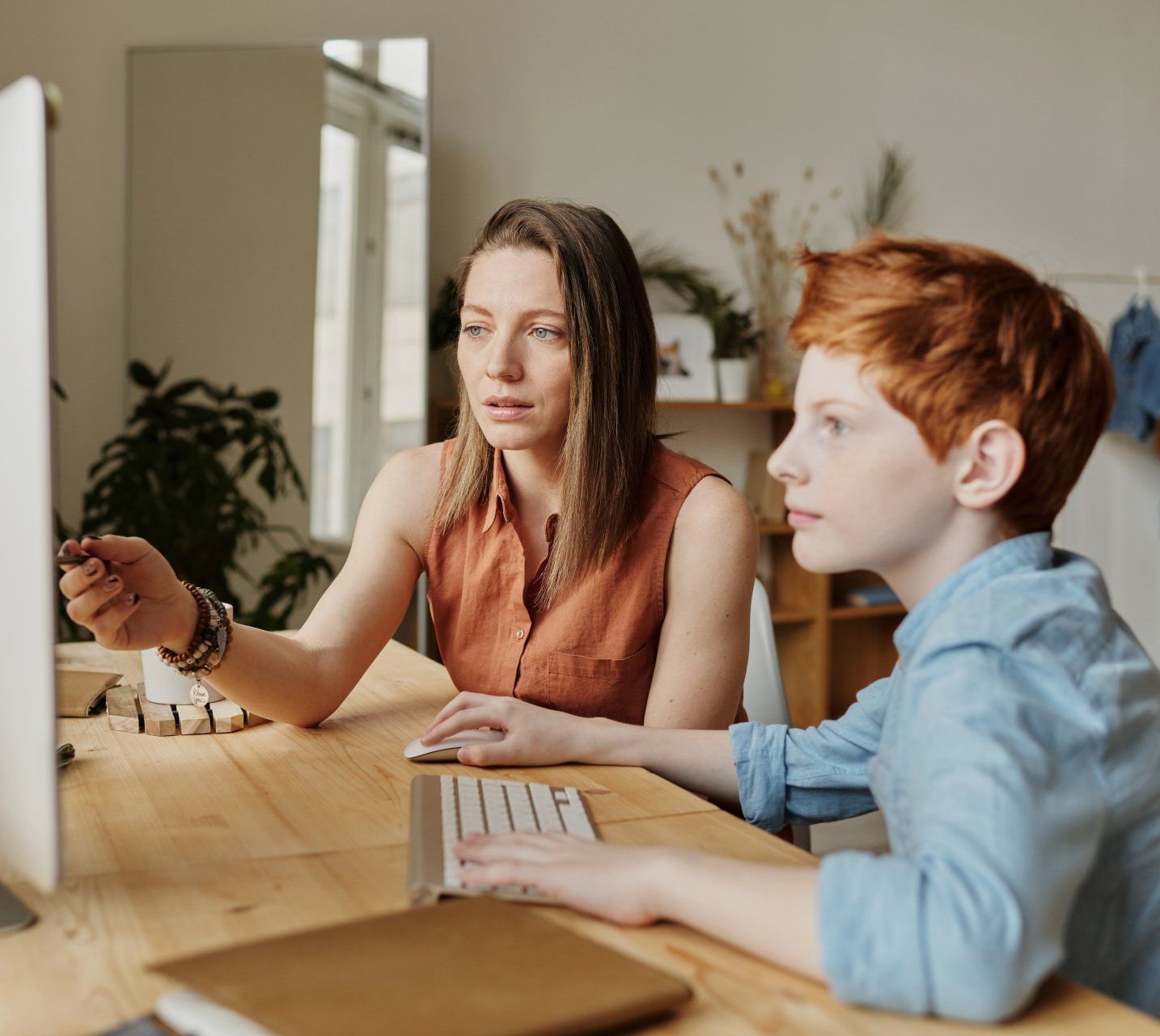 Woman teaching a young boy