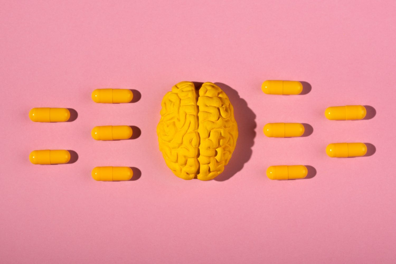 image of a yellow brain surrounded by tablets to emphasise ADHD