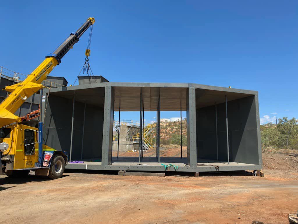 Crane Lifting A Large Piece Of Metal In A Dirt Field — Calibre Engineering In Darwin, NT