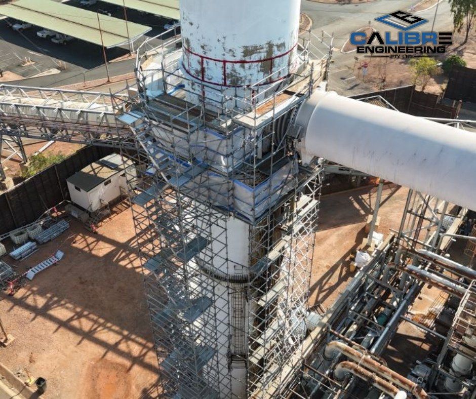 Scaffolding Surrounds a Tall Industrial Chimney — Calibre Engineering In Mica Creek, QLD