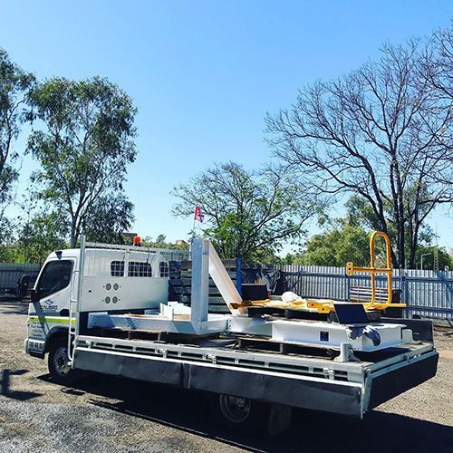 Tow Truck With A Trailer On The Back Parked In A Parking Lot — Calibre Engineering In Mica Creak, QLD