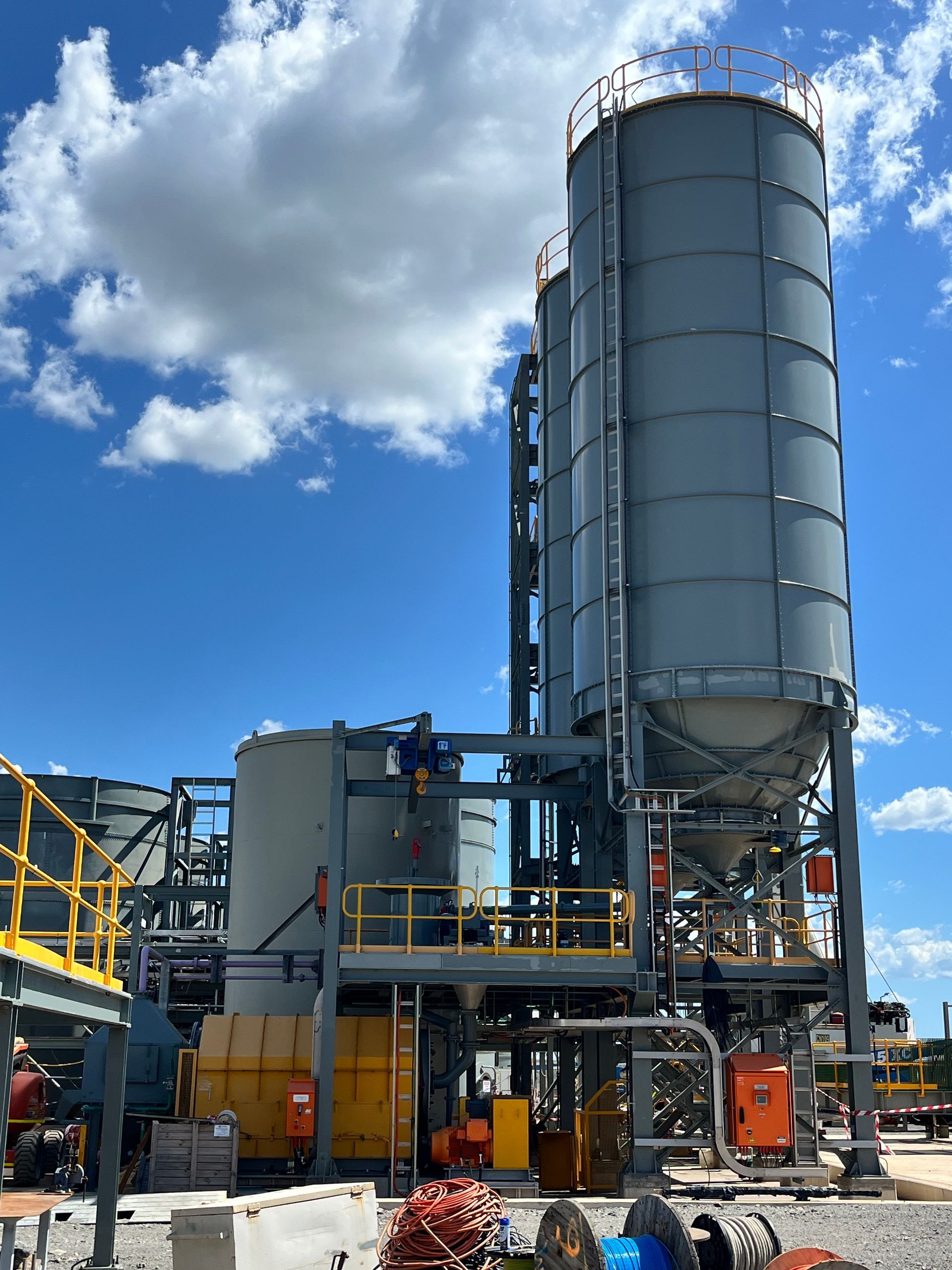A large industrial building with a blue sky and clouds in the background — Calibre Engineering In Mica Creak, QLD