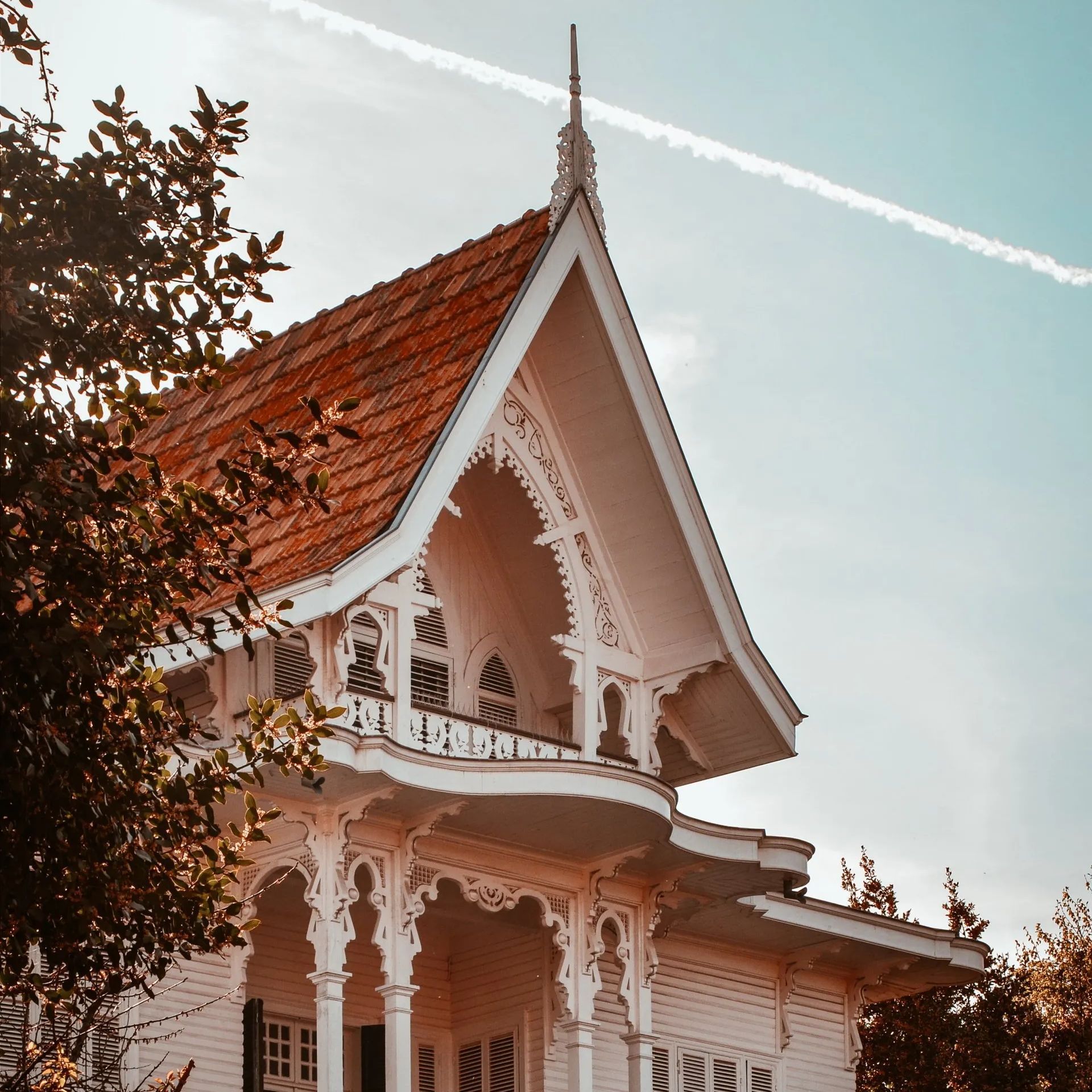A large white house with a red tiled roof