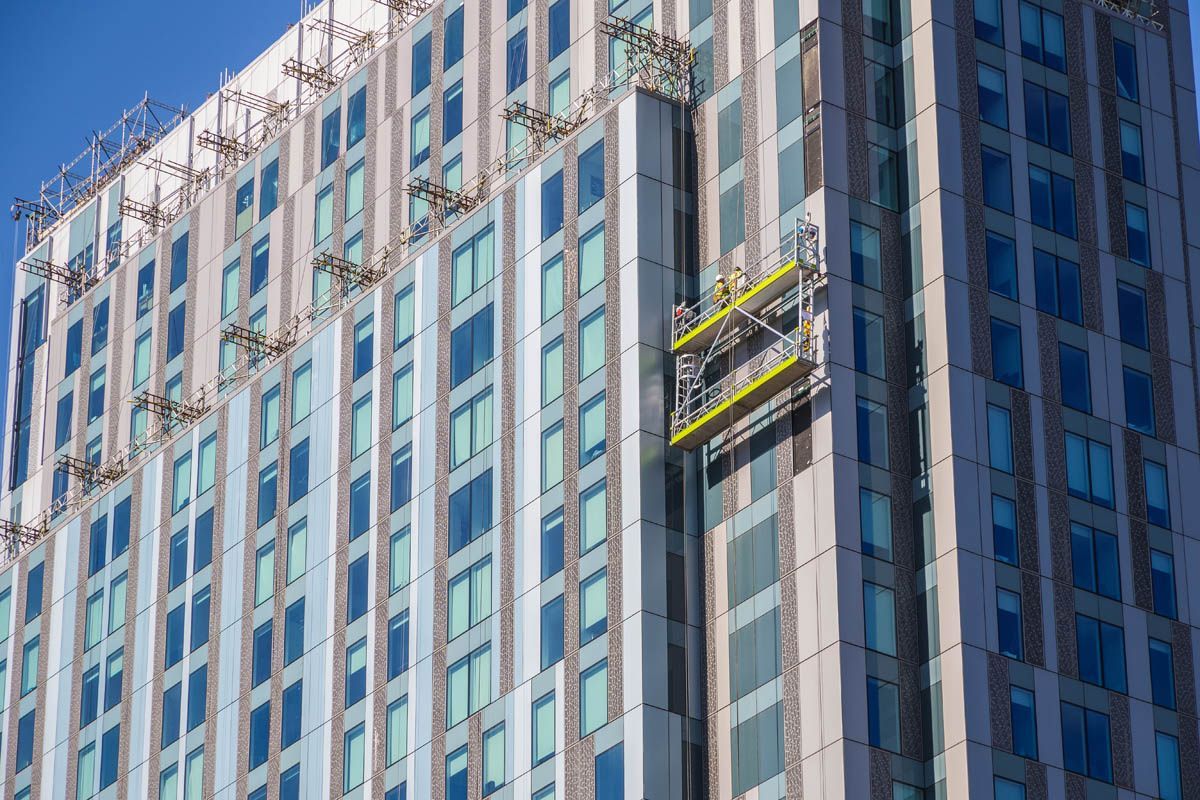 A large building with a lot of windows is being built.