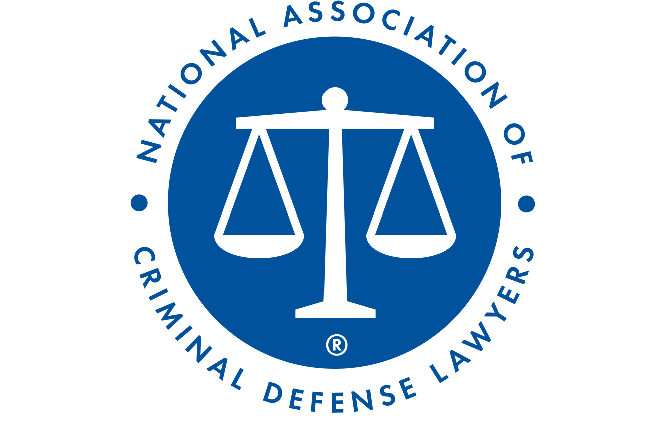 National Association of Criminal Defense Lawyers logo: Scales of justice in a blue circle with white text.