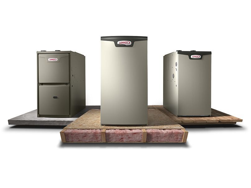Three lennox furnaces are sitting on top of a wooden floor.