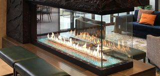 There is a fireplace in the middle of the room.