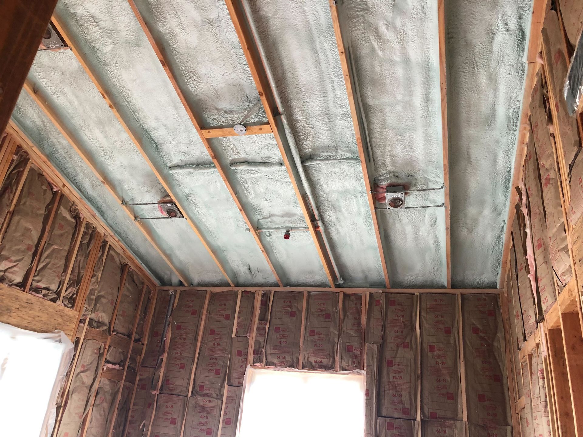 Unfinished room with exposed brick walls and a concrete ceiling under construction