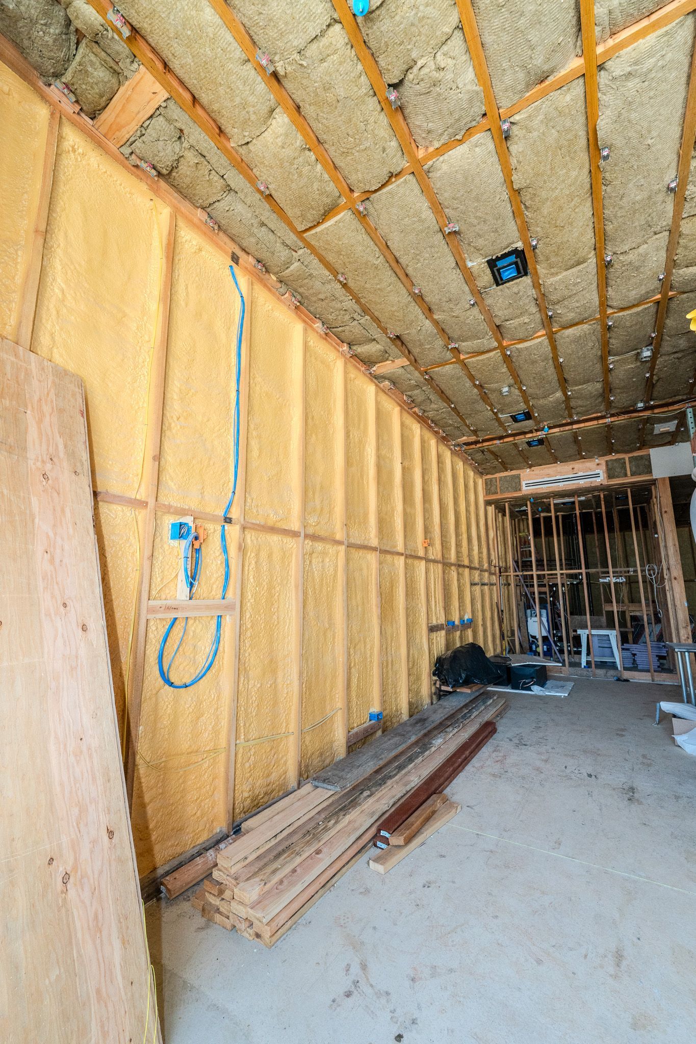 Insulated attic roof with skylight and exposed wooden beams