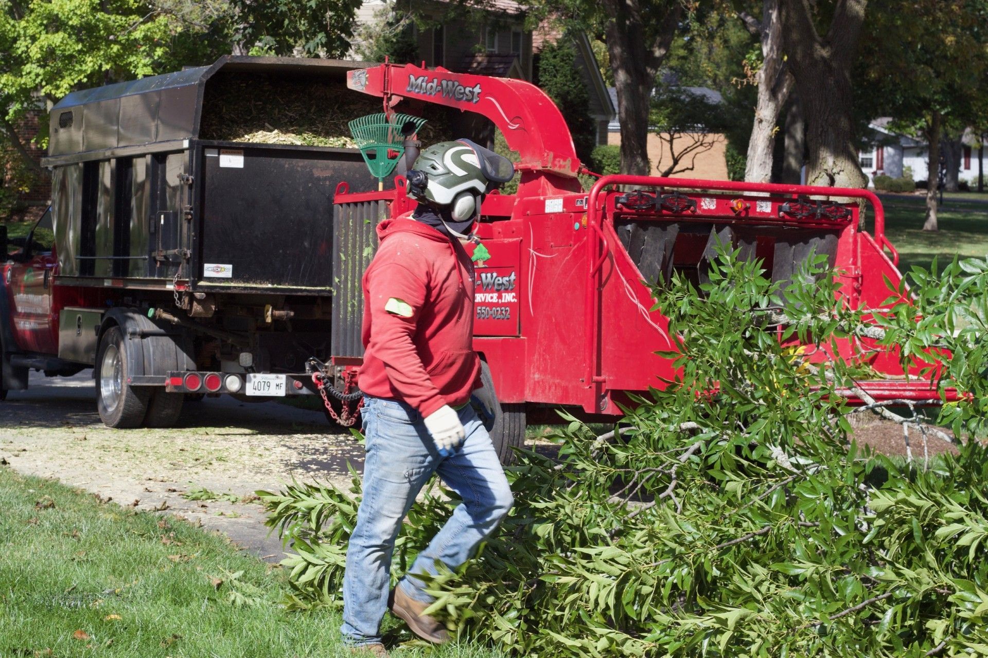 Mid-West Tree Service Experts Inc. team using a chipper in Lake Zurich, IL.