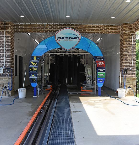 A car wash with a blue archway that says pwrstar