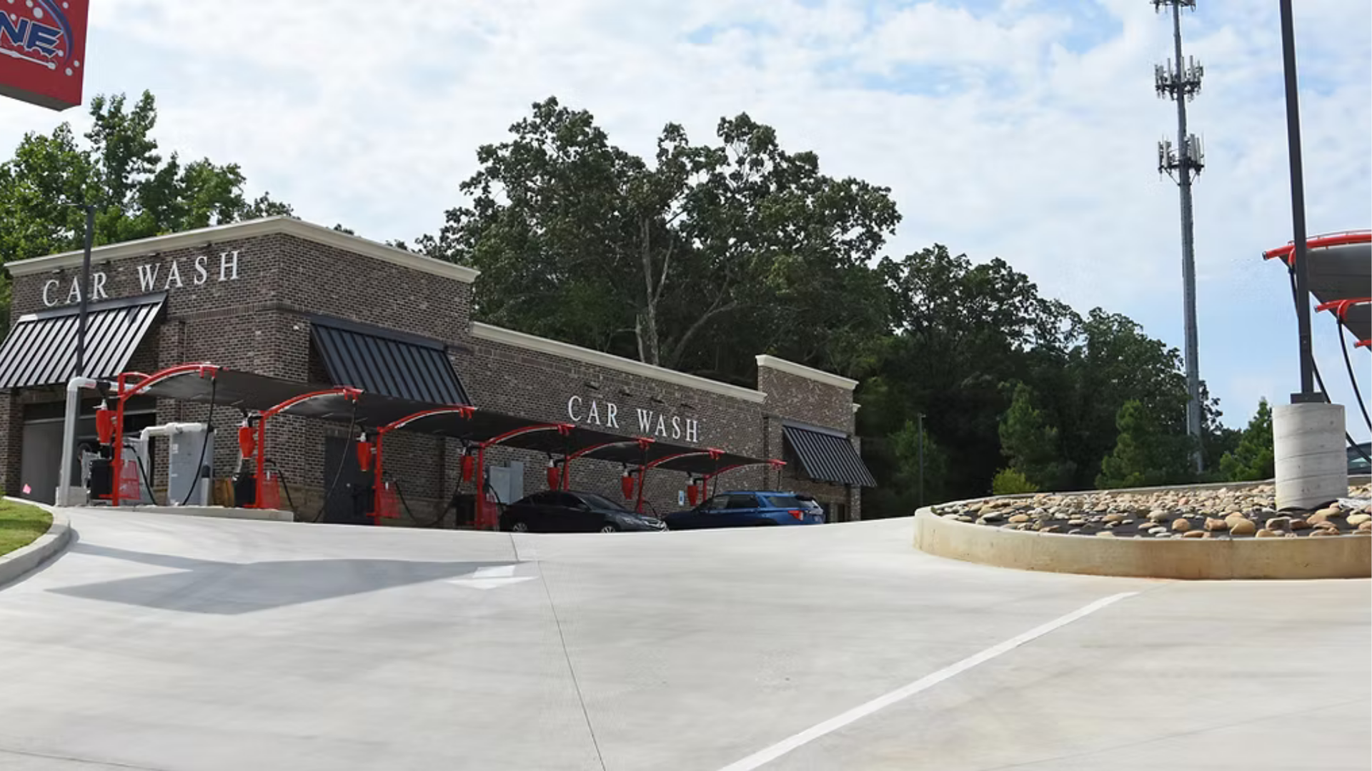 A car wash with a lot of cars parked in front of it