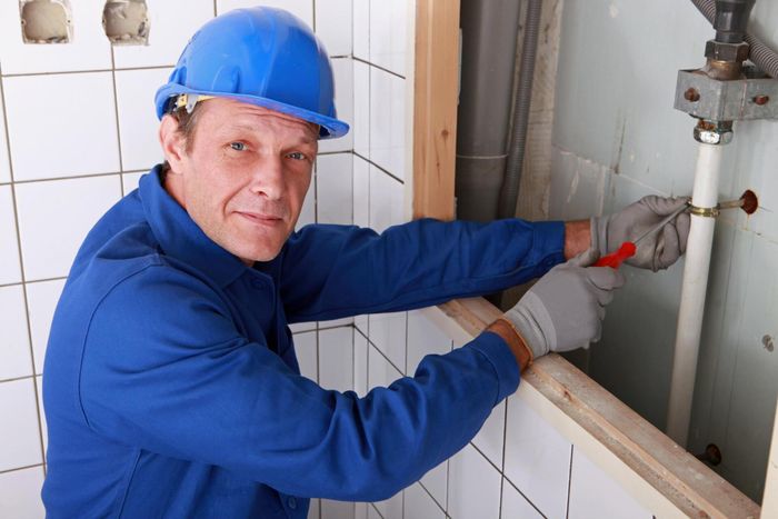 man fixing the water pipe