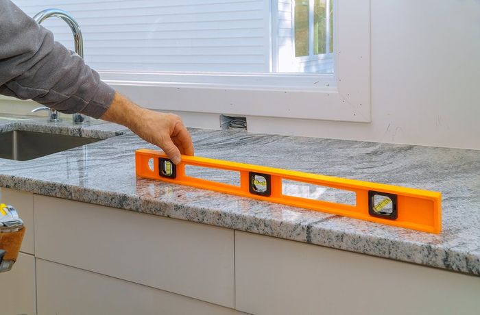 worker measuring the kitchen top