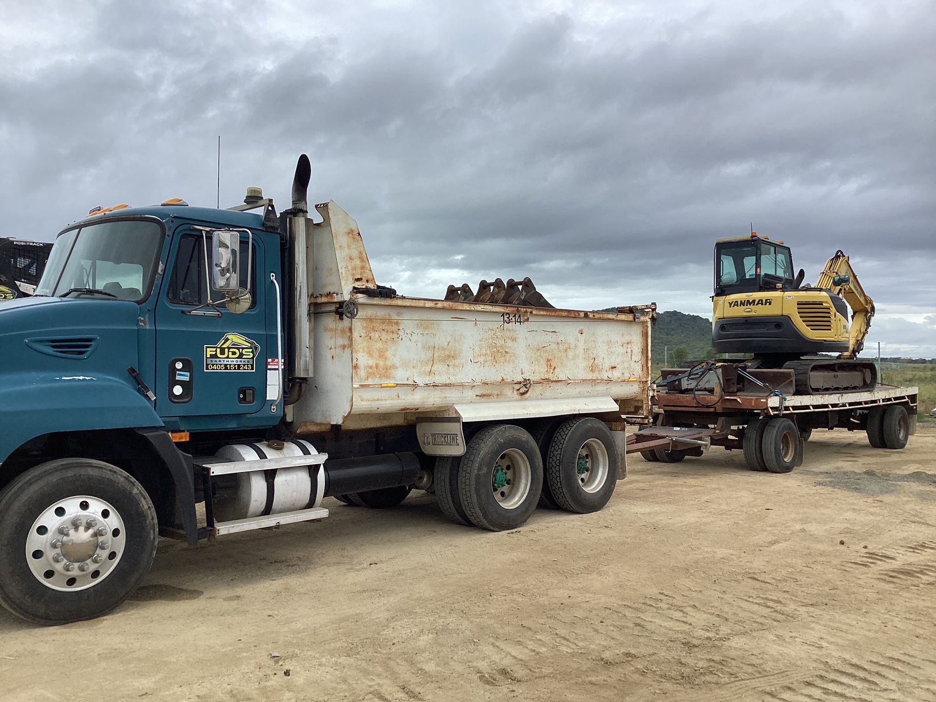 A Bulldozer is Clearing a Forest of Trees and Roots — Fud's Concreting In Bowen, QLD