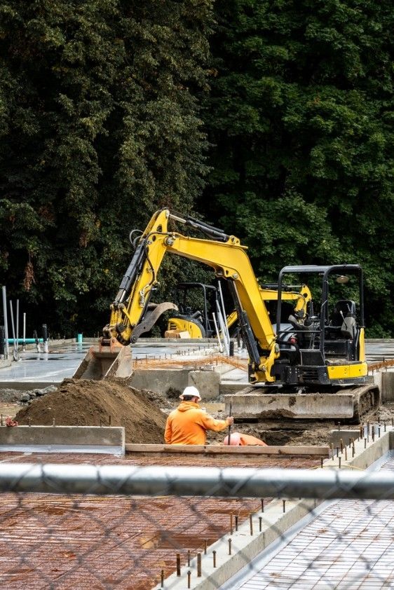 A Construction Site With a Yellow Excavator — Fud's Concreting In Bowen, QLD