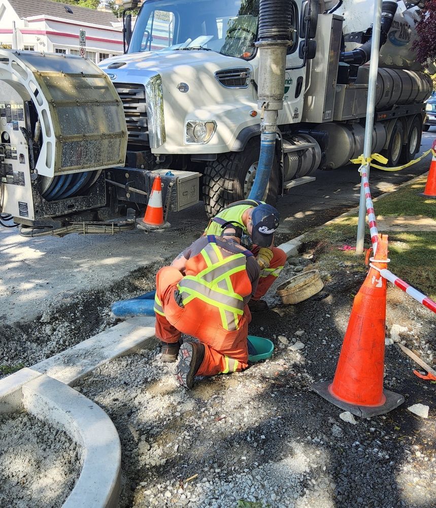 Road Worker in Orange Safety Gear Repairing Pavement — Fud's Concreting In Bowen, QLD