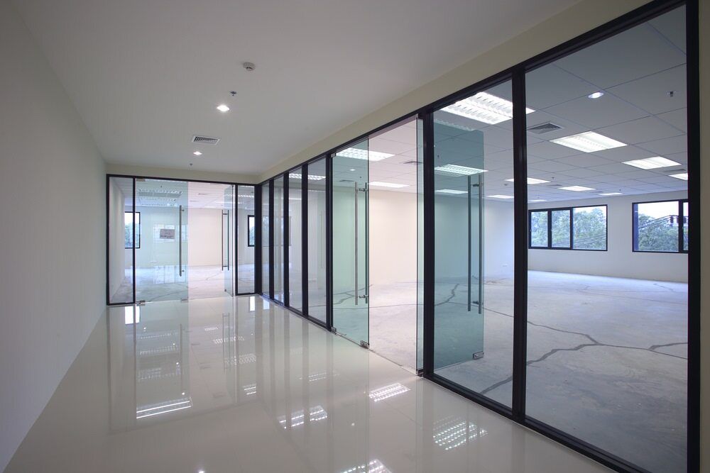 An Empty Office Building with A Lot of Windows and Sliding Glass Doors  — Arctic Installations in Winnellie, NT