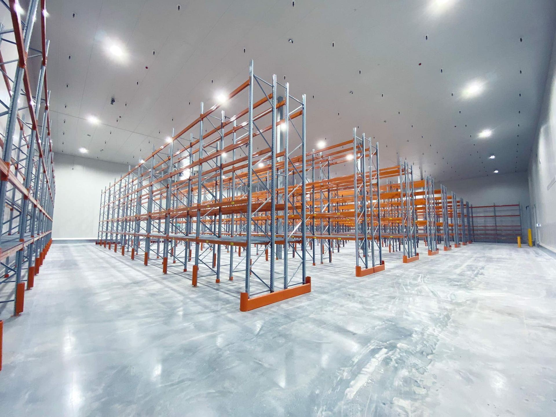A Couple of White Doors in A Room with A Red Floor — Arctic Installations in Winnellie, NT