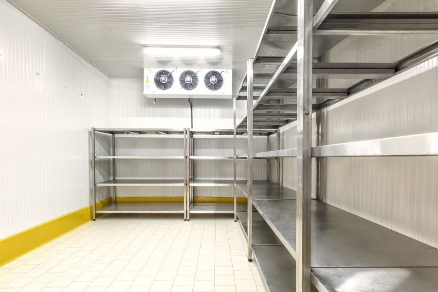 A Room with Stainless Steel Shelves and A Refrigerator — Arctic Installations in Winnellie, NT
