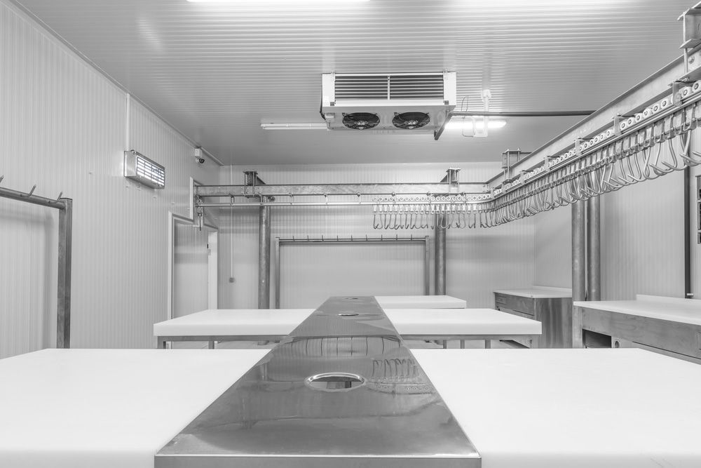 A Black and White Photo of An Empty Room with Tables and A Ceiling Fan — Arctic Installations in Winnellie, NT