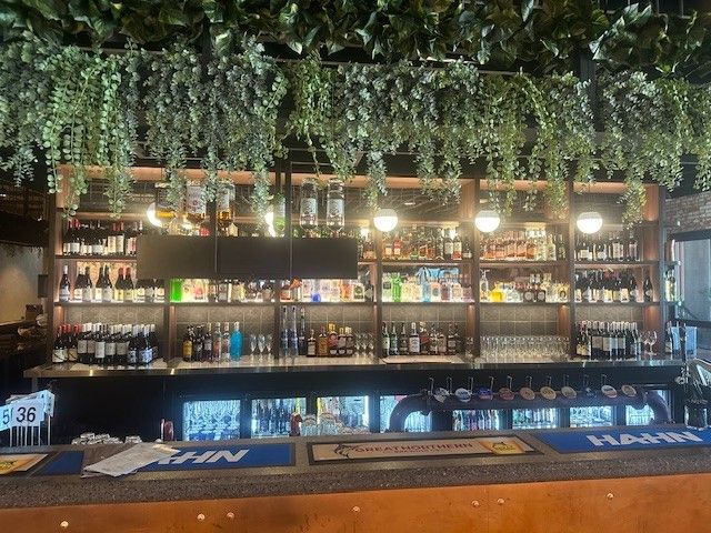 A Well-stocked Bar Counter With Shelves of Liquor Bottles — Arctic Installations in Winnellie, NT