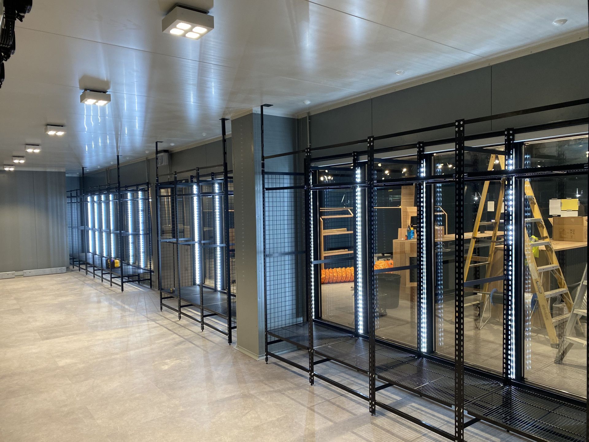 A Large Warehouse with A Lot of Doors and A Concrete Floor — Arctic Installations in Winnellie, NT