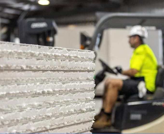 A Man in a Yellow Shirt is Driving a Forklift in a Factory — Arctic Installations in Winnellie, NT