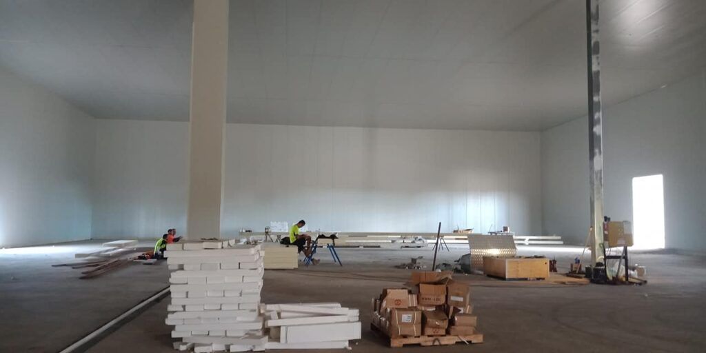 A Large Empty Warehouse with A Lot of Boxes on The Floor — Arctic Installations in Winnellie, NT