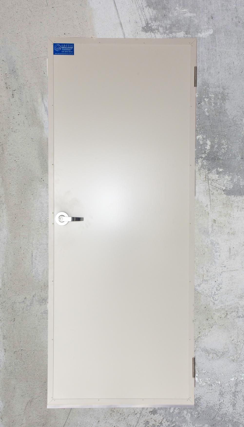 A White Door Is Sitting on A Concrete Wall — Arctic Installations in Winnellie, NT