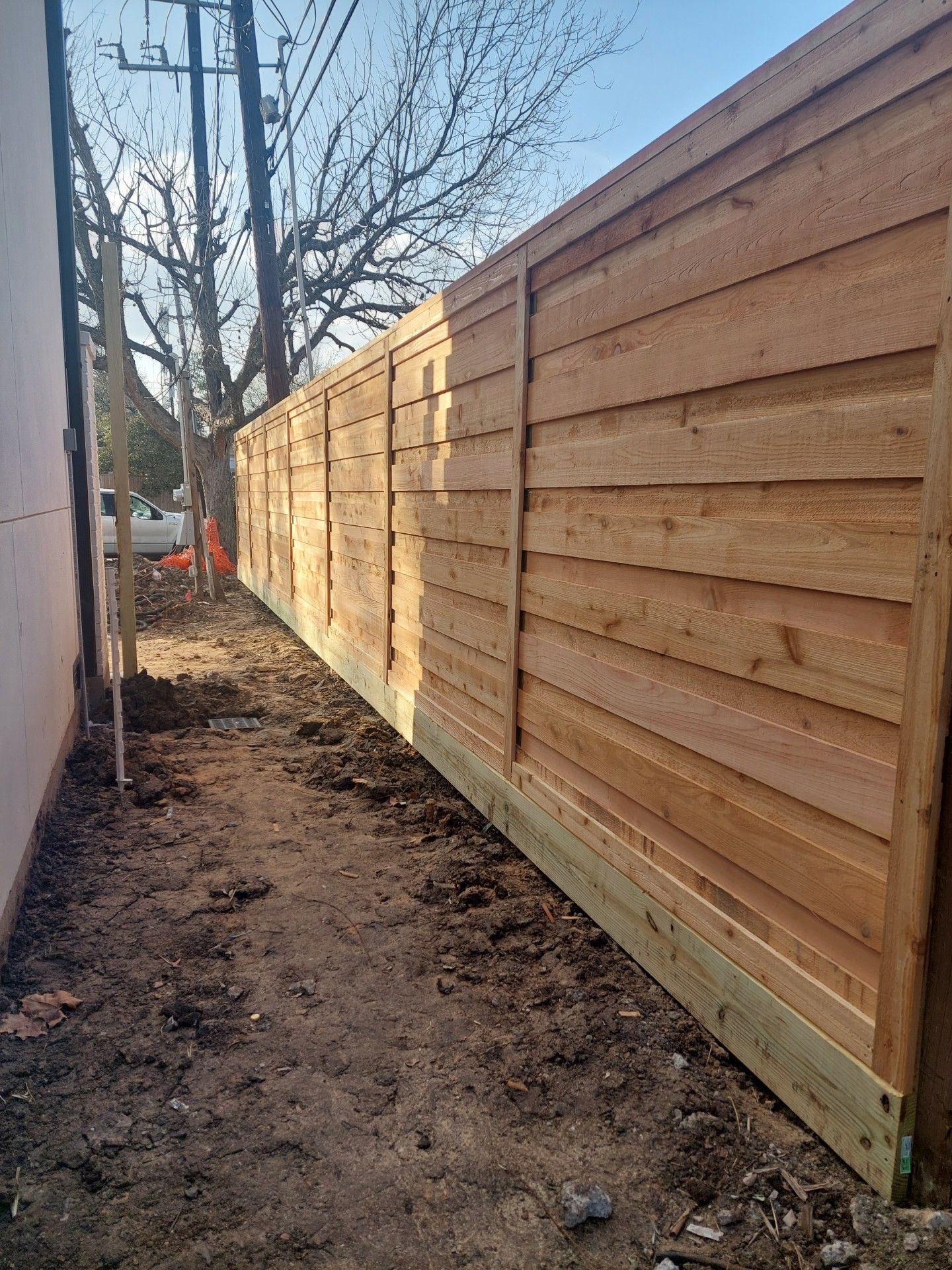 A Wooden Fence Is Being Built in The Backyard of A House - Houston, TX - Rio Grande Fence Company