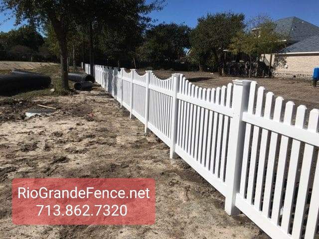 A White Picket Fence Is Sitting in The Dirt in Front of A House - Houston, TX - Rio Grande Fence Company