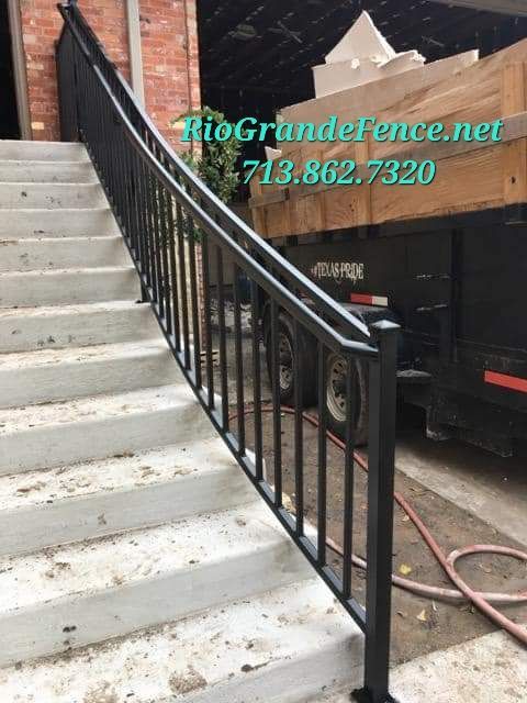 A Staircase with A Wrought Iron Railing and A Trailer in The Background - Houston, TX - Rio Grande Fence Company