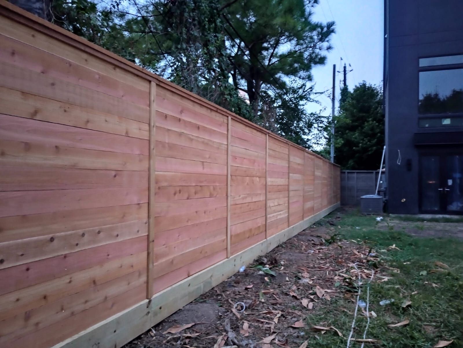 A Wooden Fence Is in The Backyard of A House - Houston, TX - Rio Grande Fence Company