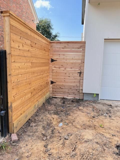 A Wooden Fence With A Gate in The Backyard of A House - Houston, TX - Rio Grande Fence Company