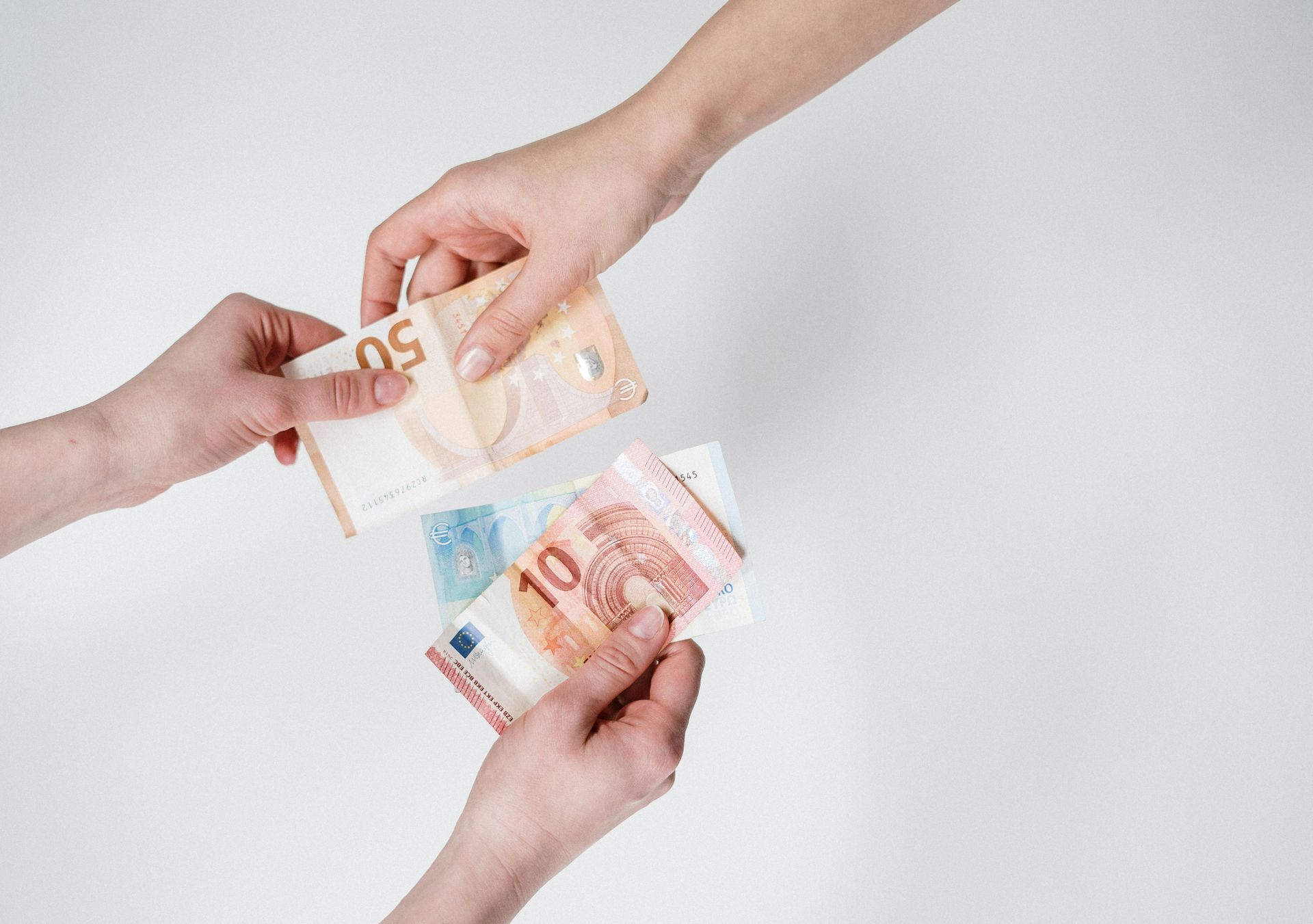 Two hands exchanging cash