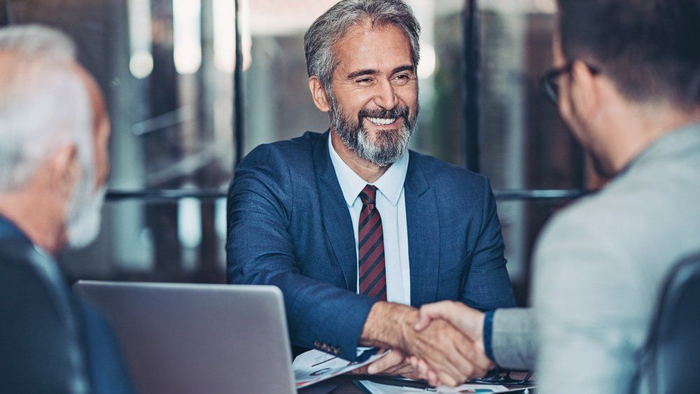 Male Insurance Agent Shaking Hands With Client — Great Falls, MT — Senior Insurance Market Male Insurance Agent Shaking Hands With Client — Great Falls, MT — Senior Insurance Market
