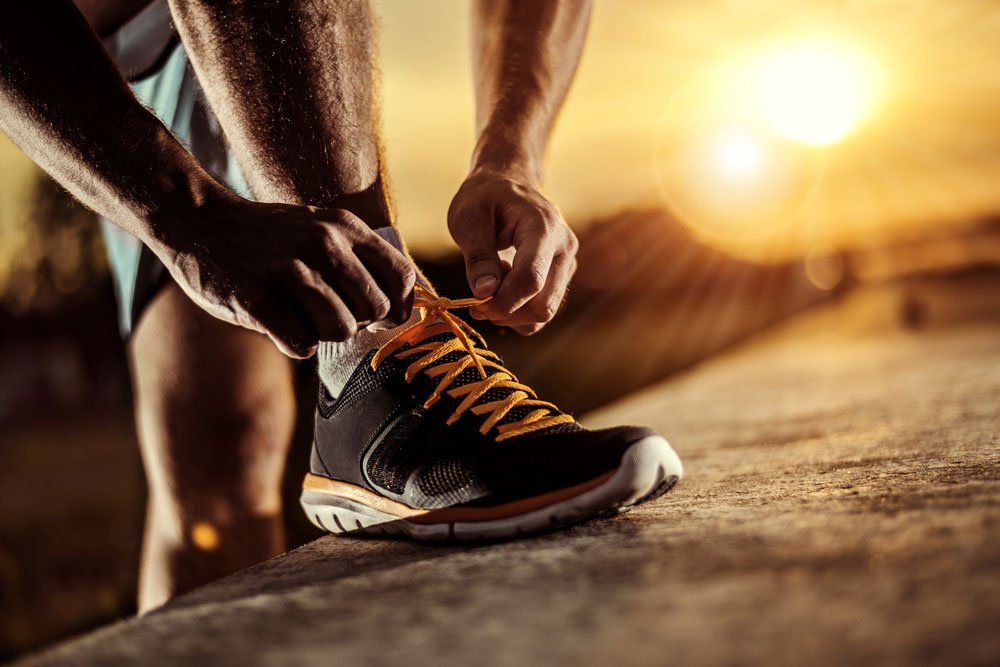 Man Tying Running Shoes — Quality Shoe Shop in Maroochydore, QLD