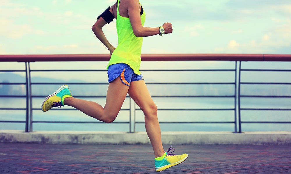 Woman Running In Bright Coloured Sneakers — Quality Shoe Shop in Maroochydore, QLD